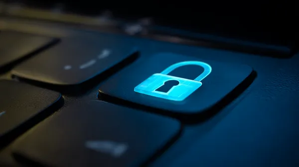 A laptop glowing with a bright login prompt in a minimalistic setup, symbolizing the protected access system at TKPK.